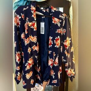 Women’s blazer. Dark navy blue. Never worn. Goes in slightly at the waist.